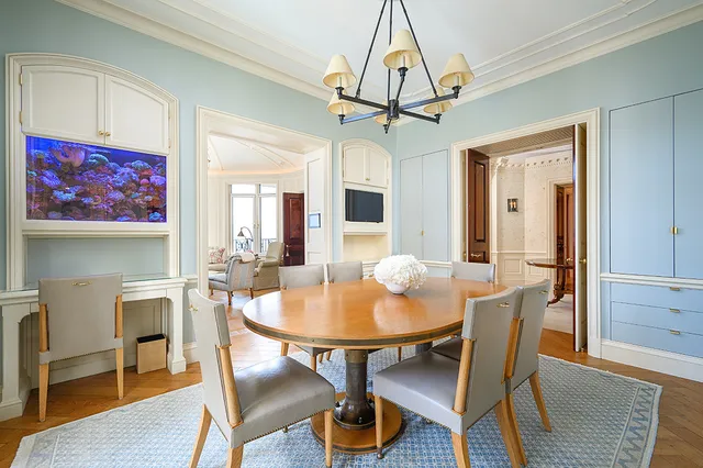 a view of a dining room with furniture a chandelier and wooden floor