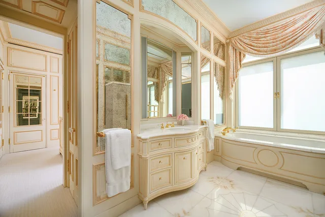 a bathroom with a granite countertop tub sink double vanity and shower