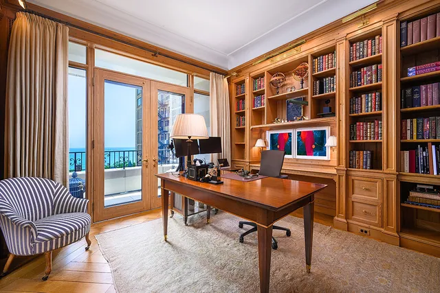 a kitchen with stainless steel appliances granite countertop a stove top oven a sink a dining table and chairs