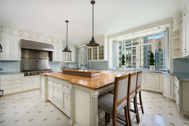 a kitchen with stainless steel appliances granite countertop a sink and a refrigerator