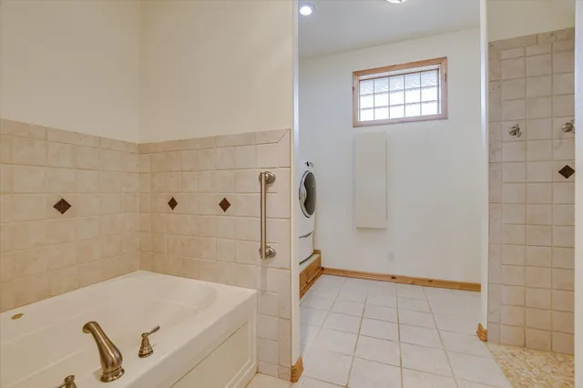 a bathroom with a tub and shower