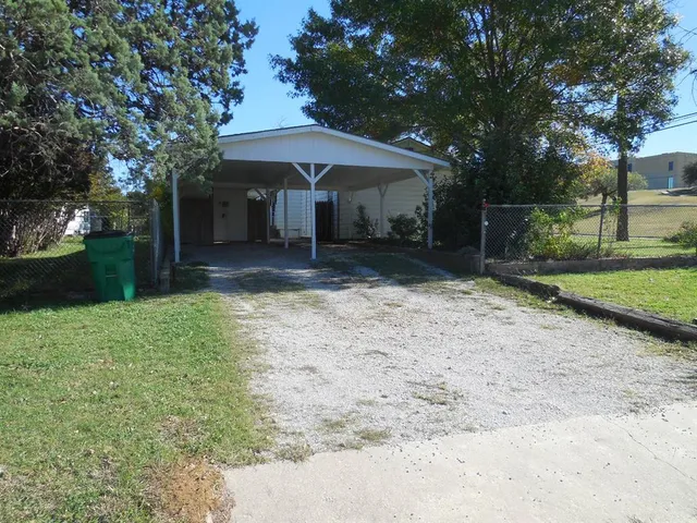 a view of a yard with a table and a chair