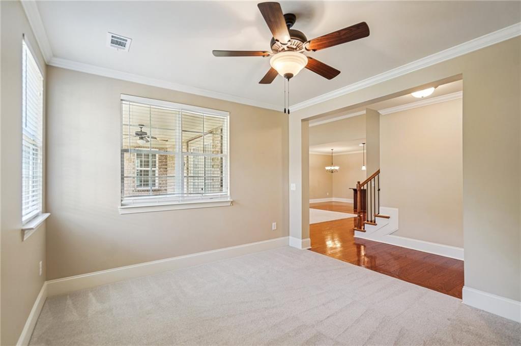 488 Townsend Street Grayson, GA 30017 - Photo 18 of 40 a bedroom with a bed and a chandelier