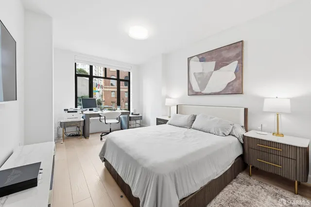 a bedroom with a bed and a lamp