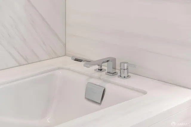 a bedroom with two beds and a large window