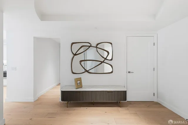 a room with wooden floor and white walls