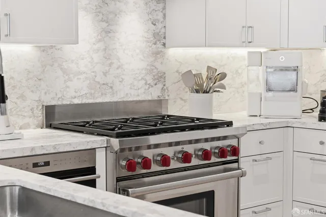 a stove top oven sitting inside of a kitchen