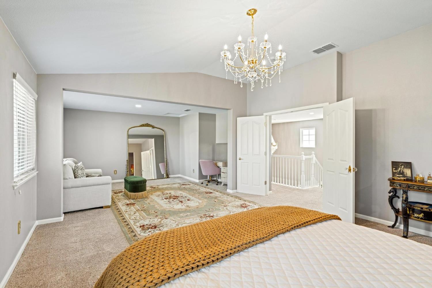 426 South Highland Avenue Ripon, CA 95366 - Photo 56 of 82 a bedroom with a large bed and a chandelier