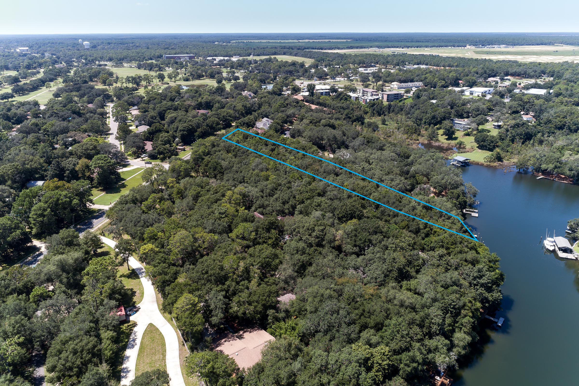 Xx Northwest Xx Nw Mooney Road Fort Walton Beach, FL 32547 - Photo 9 of 26 an aerial view of a houses with a lush green hillside