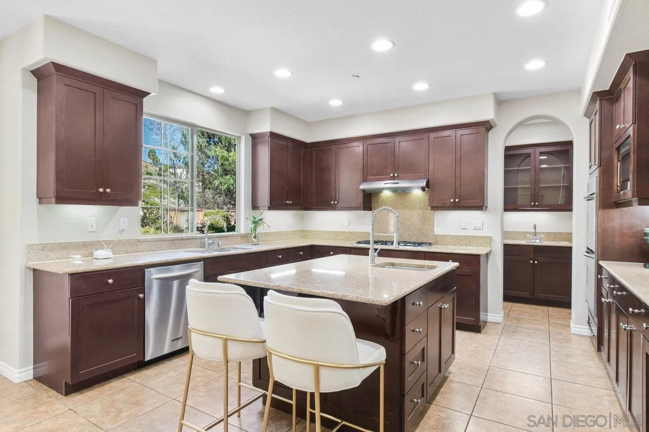 2957 Ranch Gate Road Chula Vista, CA 91914 - Photo 14 of 75 a kitchen with granite countertop a sink and white cabinets