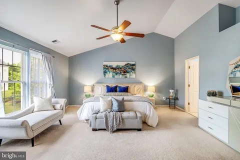 a bedroom with a bed and a couch
