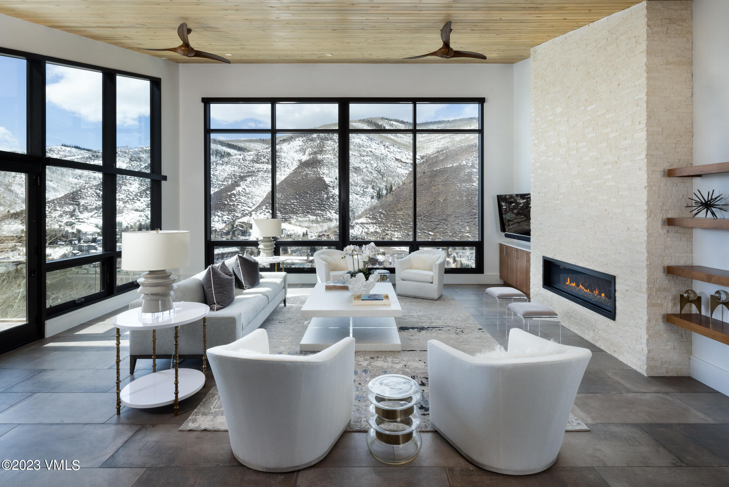 a living room with couches and a large window with outer view