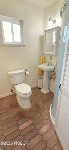 a bathroom with a sink toilet and mirror