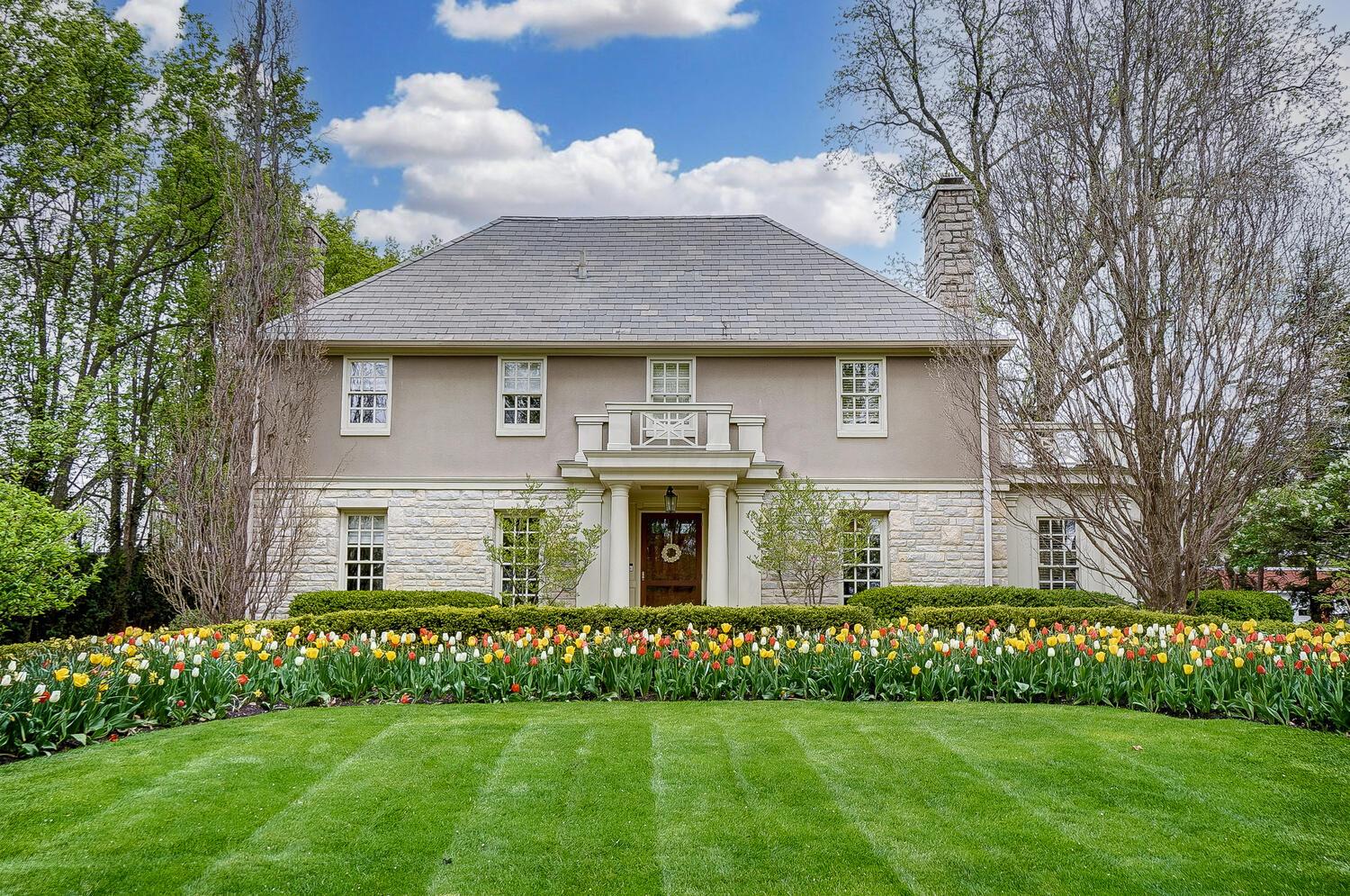 Wonderful curb appeal with circular paver driveway and mature landscaping