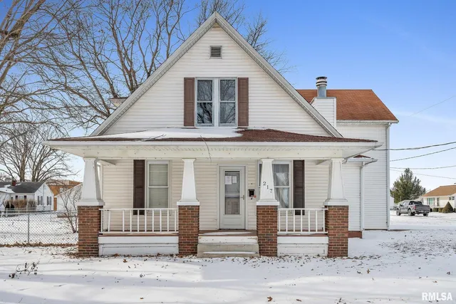 a view of a white house with tree s