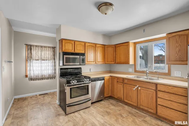 a kitchen with stainless steel appliances granite countertop a stove sink and microwave