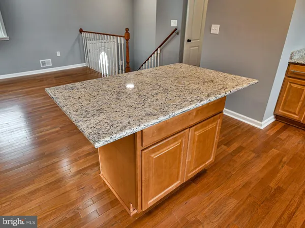 a view of kitchen island with wooden floor