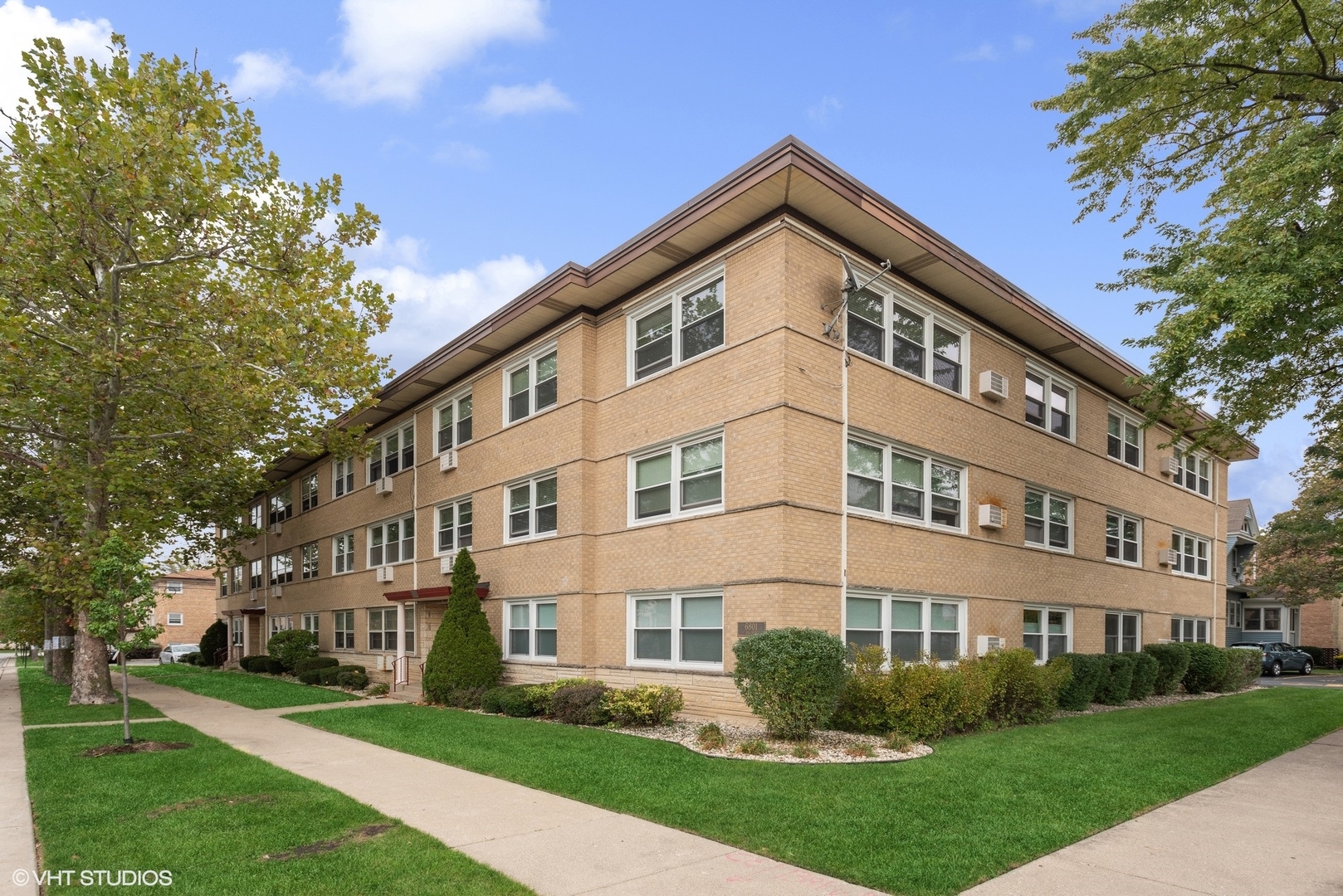 6817 North Ozark Avenue, Unit 3B Chicago, IL 60631 - Photo 1 of 13 a front view of a house with a yard