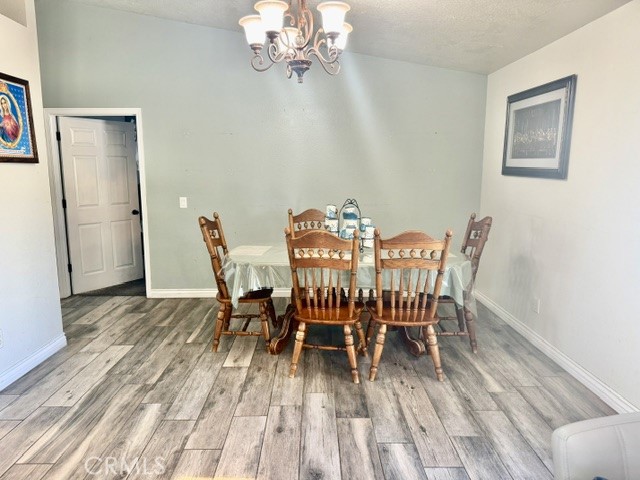 13375 Rincon Road Apple Valley, CA 92308 - Photo 18 of 72 a view of a dining room with furniture and wooden floor