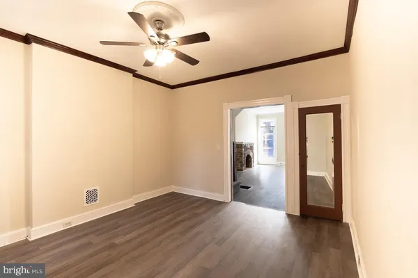 a view of an empty room with wooden floor