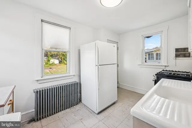 a kitchen with a sink and a stove top oven
