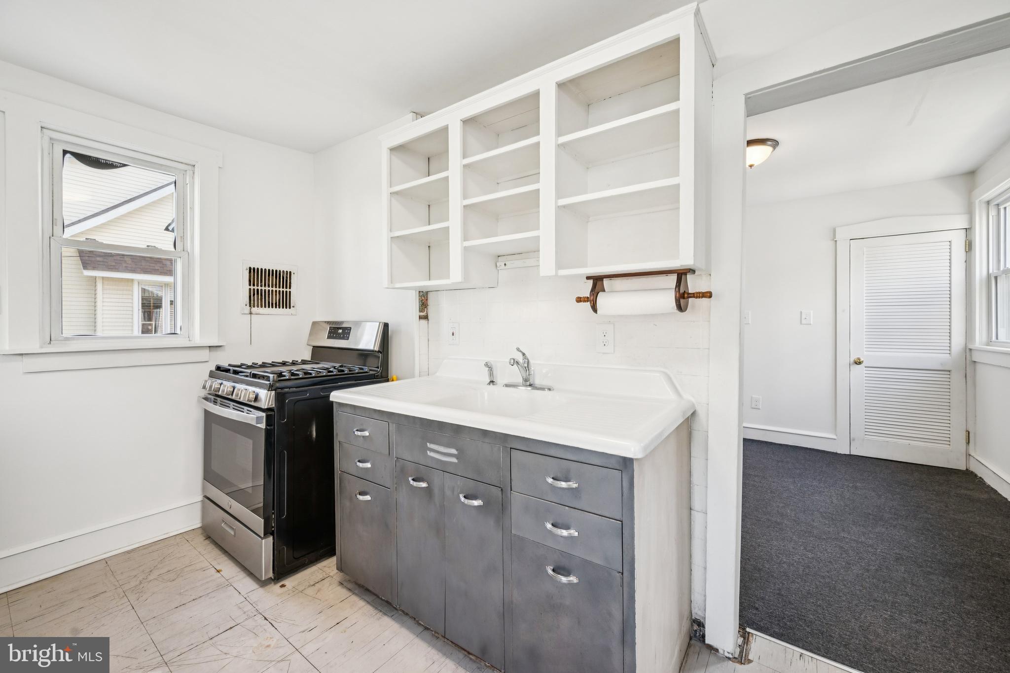 211 Newton Avenue Oaklyn, NJ 08107 - Photo 12 of 25 a kitchen with a sink and a stove top oven