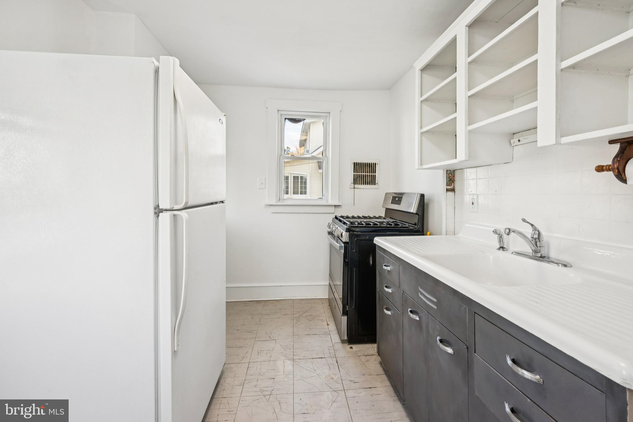 211 Newton Avenue Oaklyn, NJ 08107 - Photo 13 of 25 a kitchen with a sink appliances and cabinets