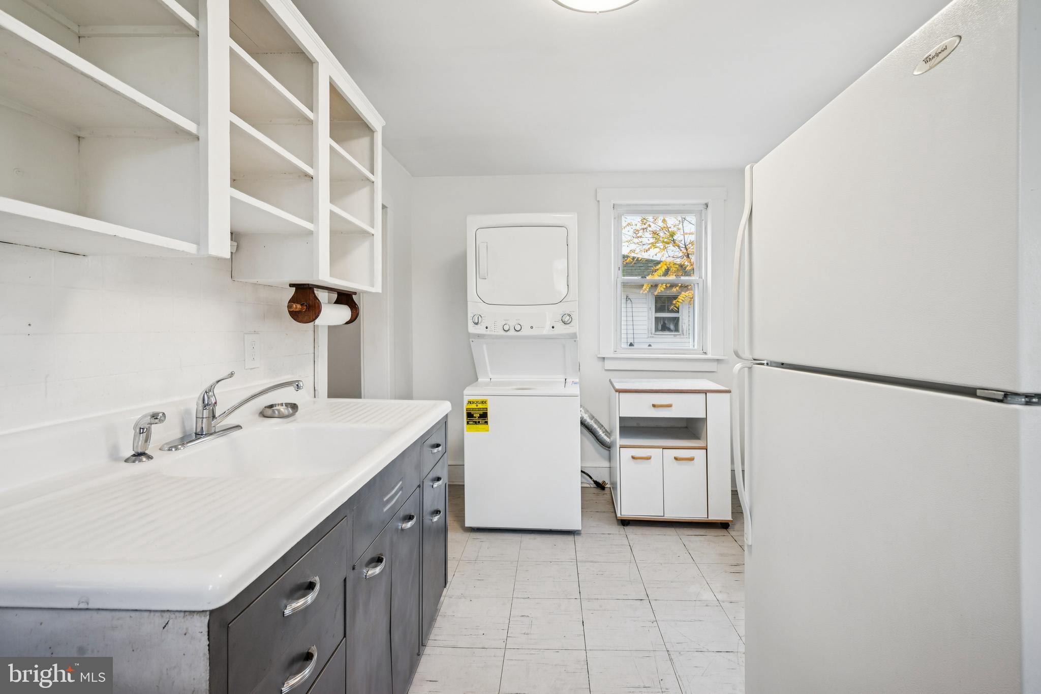 211 Newton Avenue Oaklyn, NJ 08107 - Photo 14 of 25 a kitchen with a sink and a refrigerator
