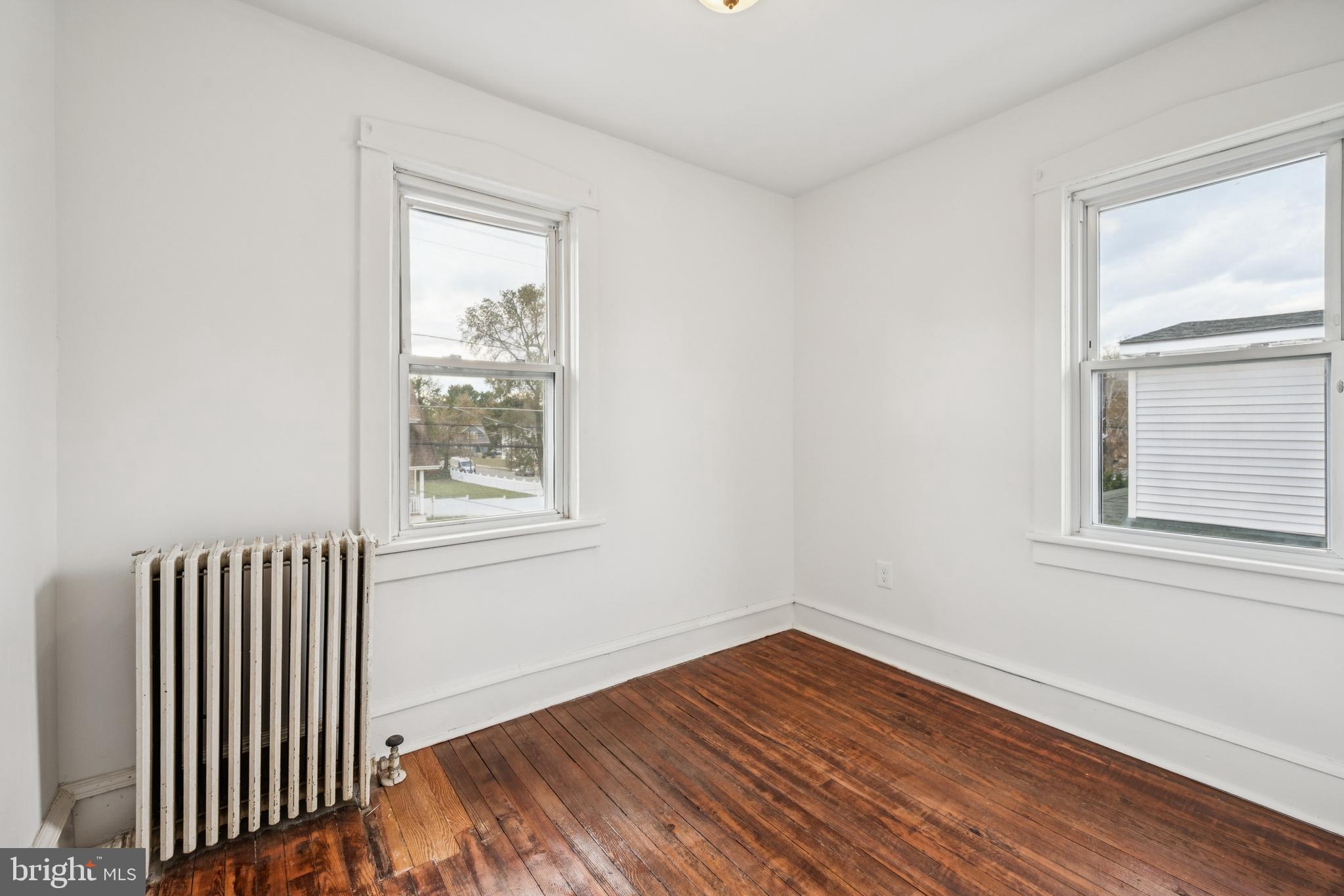 211 Newton Avenue Oaklyn, NJ 08107 - Photo 17 of 25 an empty room with wooden floor and windows