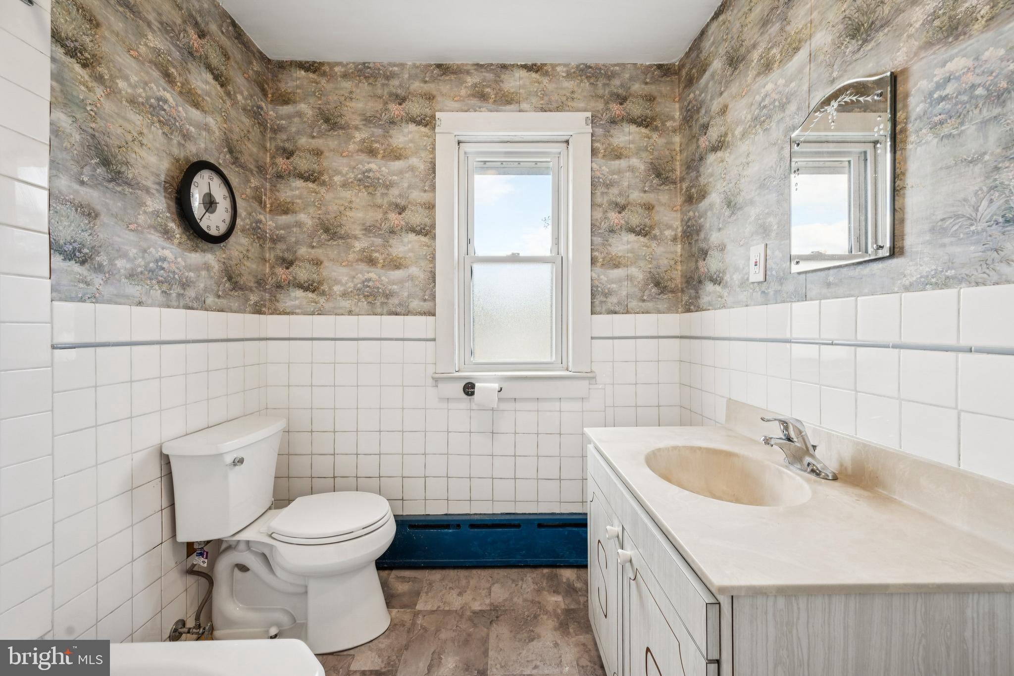 211 Newton Avenue Oaklyn, NJ 08107 - Photo 18 of 25 a bathroom with a sink and mirror with toilet