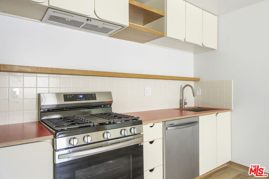 3361 Hamilton Way Los Angeles, CA 90026 - Photo 16 of 25 a stove top oven sitting inside of a kitchen