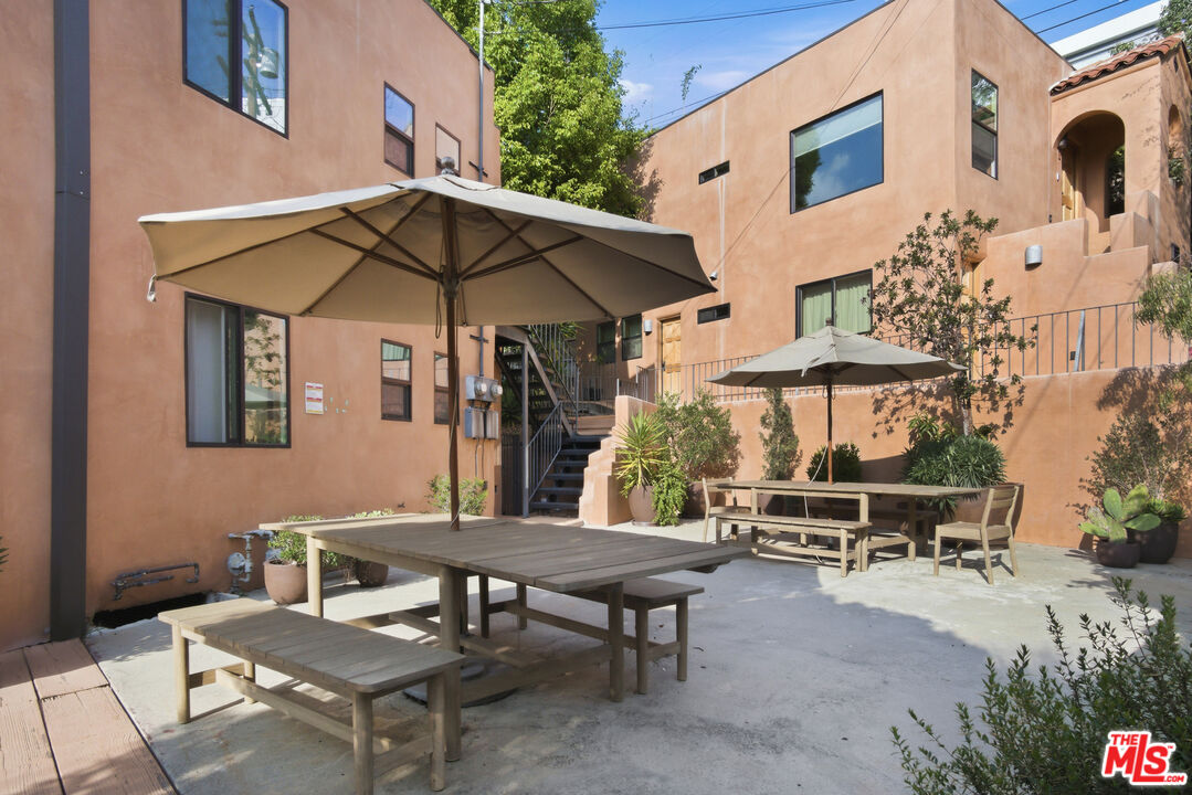 3361 Hamilton Way Los Angeles, CA 90026 - Photo 4 of 25 a backyard of a house with table and chairs under an umbrella