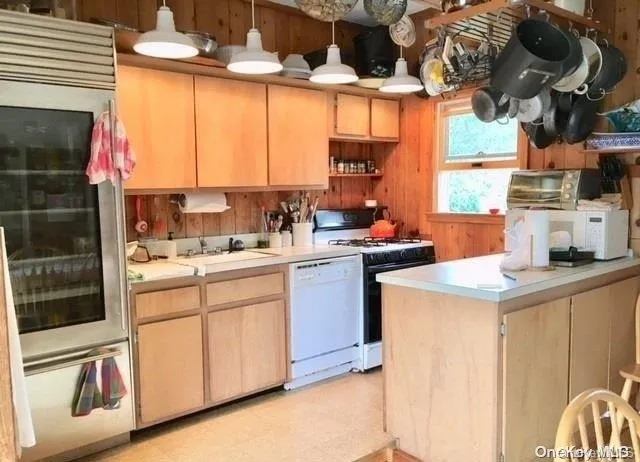 a kitchen with a stove a sink and a microwave