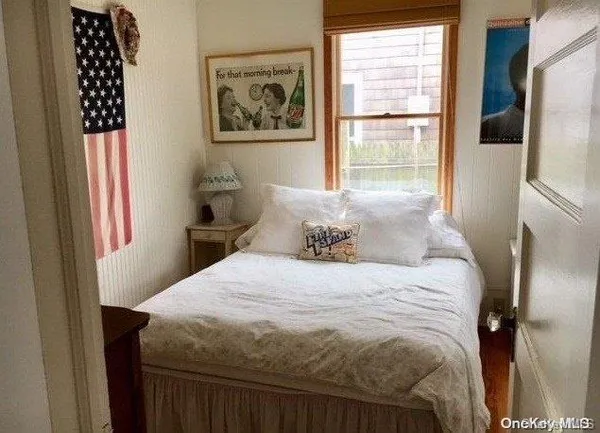 a bedroom with a bed and a window