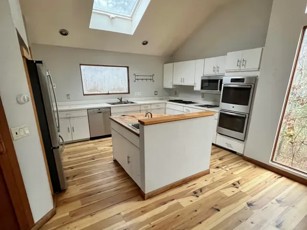 a view of a dining room with furniture wooden floor and chandelier