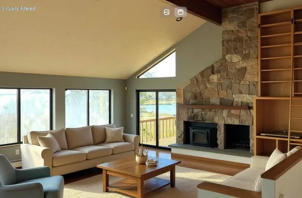 a living room with furniture a fireplace and a large window
