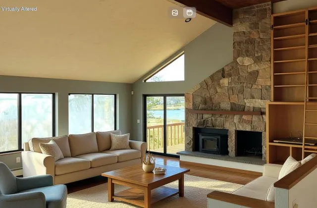a living room with furniture a fireplace and a large window