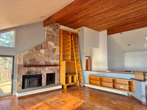 a living room with furniture pool table and a fireplace