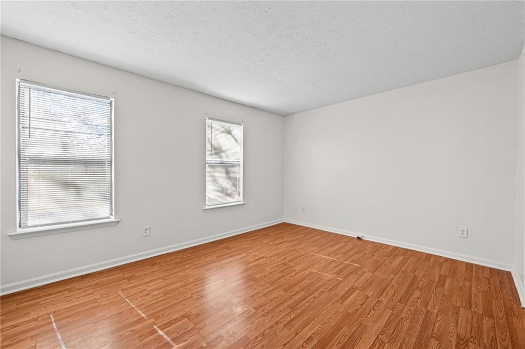 1222 Ridgecrest Lane Southeast Smyrna, GA 30080 - Photo 16 of 27 a view of an empty room with wooden floor and a window