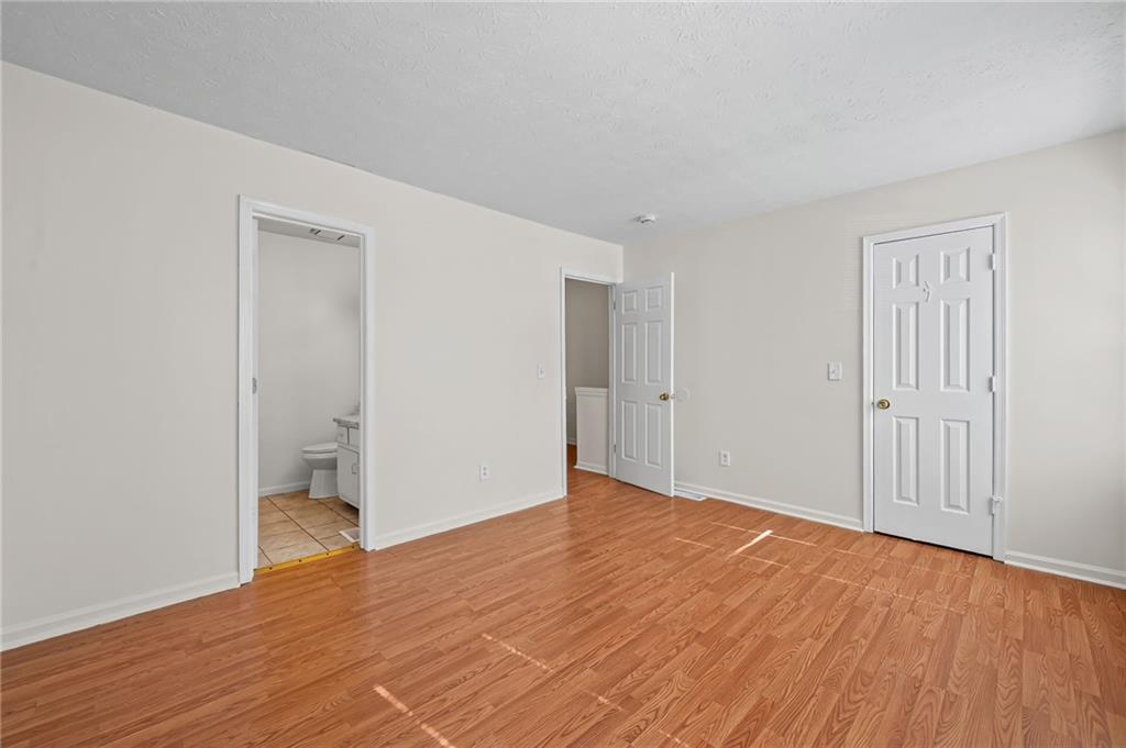 1222 Ridgecrest Lane Southeast Smyrna, GA 30080 - Photo 18 of 27 a view of an empty room with wooden floor and closet