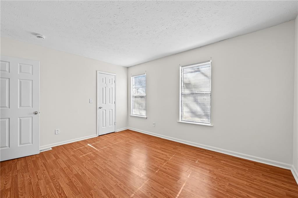 1222 Ridgecrest Lane Southeast Smyrna, GA 30080 - Photo 19 of 27 a view of empty room with wooden floor and fan