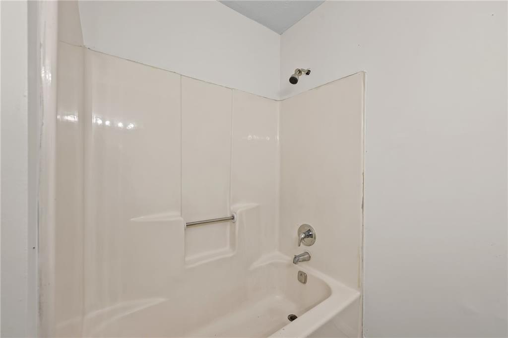 1222 Ridgecrest Lane Southeast Smyrna, GA 30080 - Photo 21 of 27 a white bath tub sitting next to a white sink and vanity
