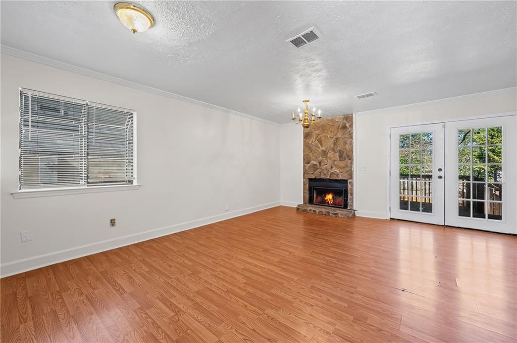 1222 Ridgecrest Lane Southeast Smyrna, GA 30080 - Photo 6 of 27 a view of an empty room with wooden floor and a window