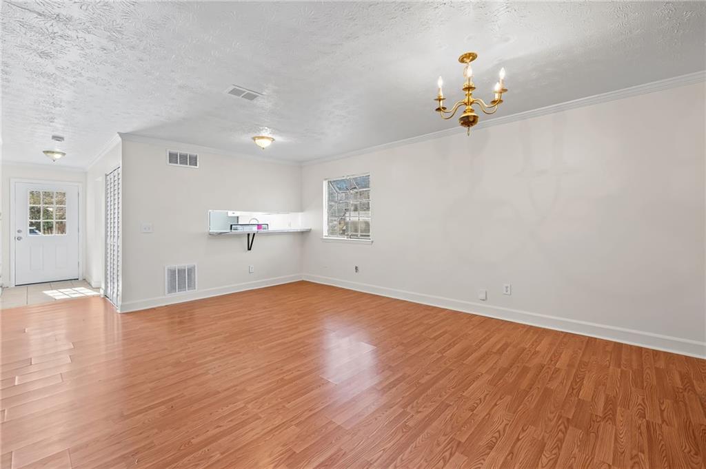 1222 Ridgecrest Lane Southeast Smyrna, GA 30080 - Photo 9 of 27 wooden floor in an empty room with a window