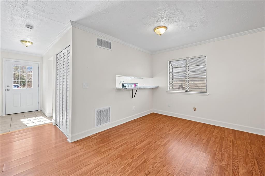 1222 Ridgecrest Lane Southeast Smyrna, GA 30080 - Photo 10 of 27 a view of empty room with wooden floor and fan