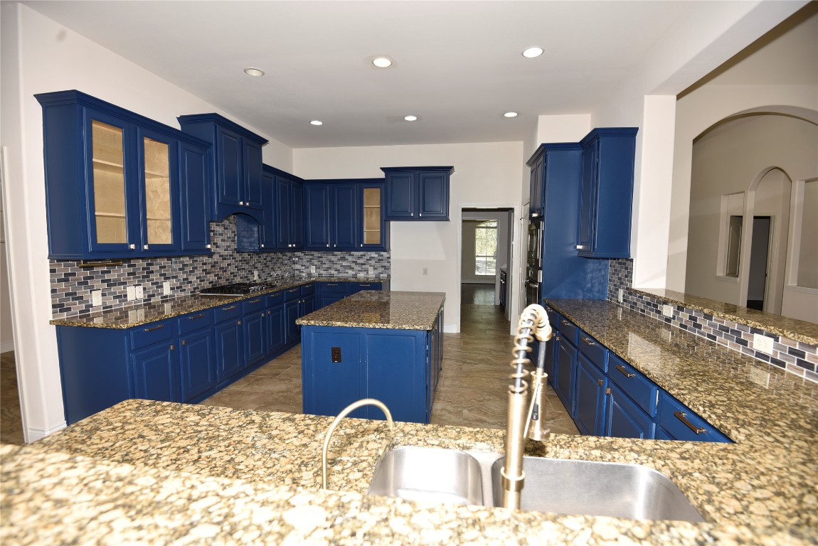 18610 Lena Trail Drive Spring, TX 77388 - Photo 11 of 47 a kitchen with stainless steel appliances kitchen island granite countertop wooden cabinets and granite counter tops