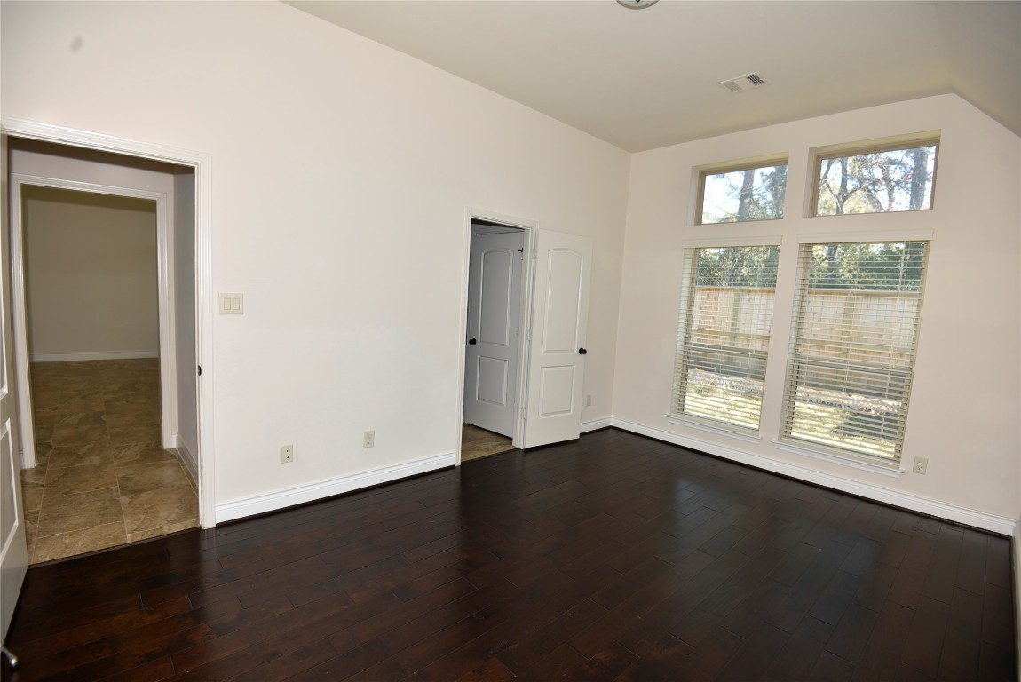 18610 Lena Trail Drive Spring, TX 77388 - Photo 35 of 47 an empty room with wooden floor and windows