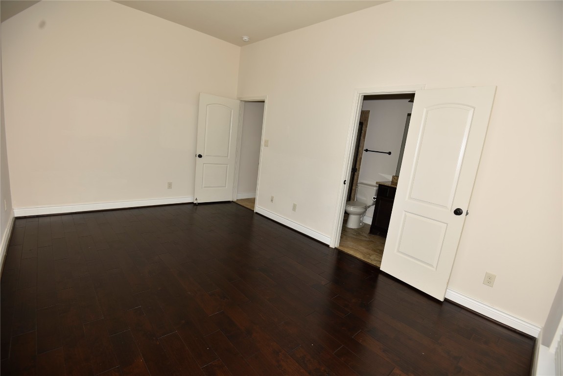 18610 Lena Trail Drive Spring, TX 77388 - Photo 36 of 47 an empty room with wooden floor and white walls