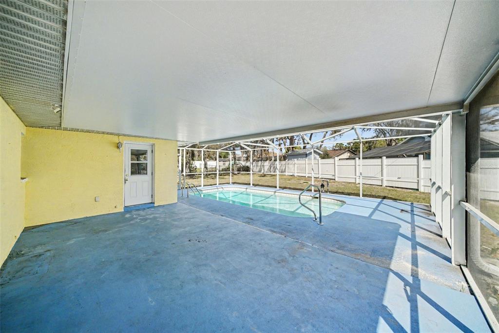 113 Ruskin Avenue Spring Hill, FL 34606 - Photo 24 of 32 a view of an empty room with wooden floor