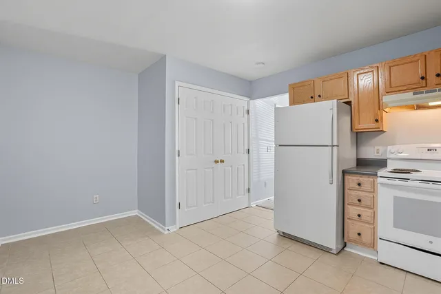 a utility room with cabinets washer and dryer